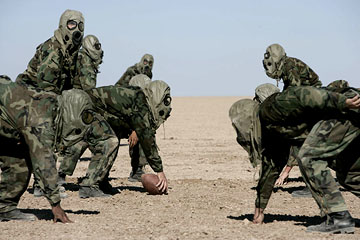 Football in the desert in chemical gear 